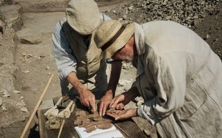 Archaeologists Johann Csar and Ferdinand Hirschhofer examine scraps of Roman-era papyrus that describe the death of Nero's wife, Poppaea Sabina.