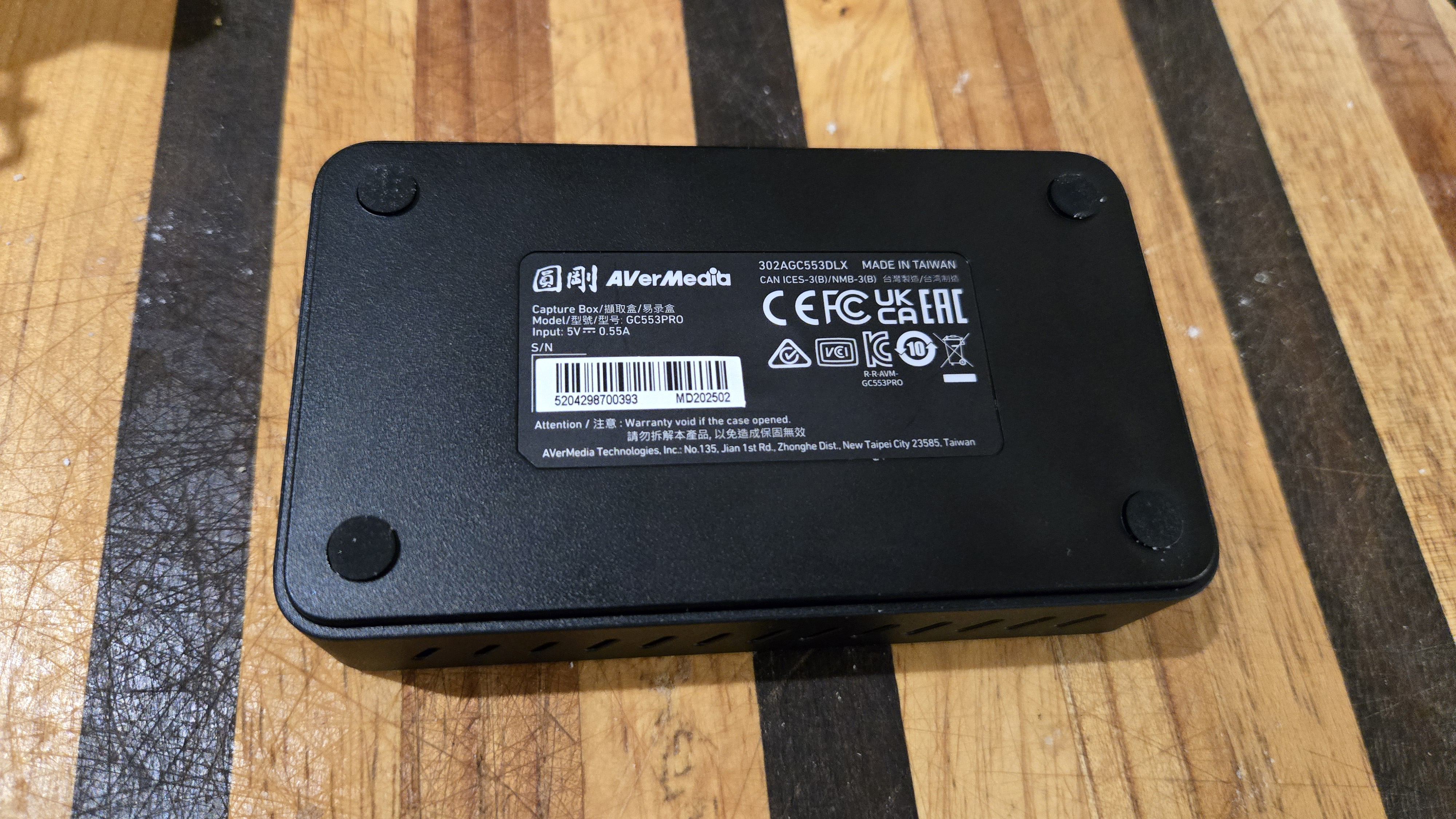 An AverMedia external capture card on a chair.