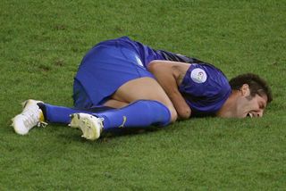 Italy defender Marco Materazzi lies on the pitch after being headbutted by France's Zinedine Zidane in the 2006 World Cup final.