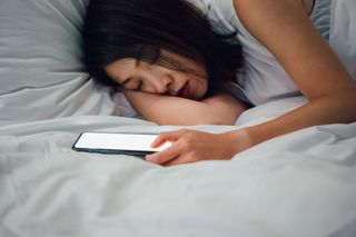 A woman using one of the best sleep tracker apps