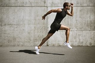 A young man runs, swinging his arms.