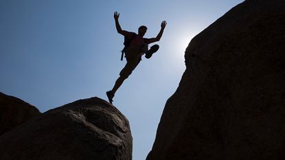 Man jumping over chasm
