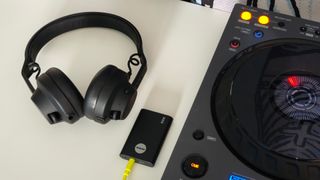 A pair of headphones next to a DJ controller