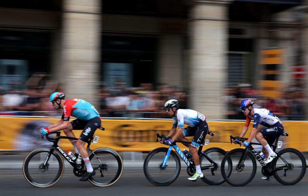 Lotto Dstnys Belgian rider Frederik Frison L Movistar Teams Portuguese rider Nelson Oliveira C and Israel Premier Techs Australian rider Simon Clarke cycle in a breakaway during the 21st and final stage of the 110th edition of the Tour de France cycling race 115 km between SaintQuentinenYvelines and the ChampsElysees in Paris on July 23 2023 Photo by Thomas SAMSON AFP Photo by THOMAS SAMSONAFP via Getty Images