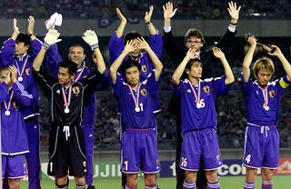 Japan players wave to their supporters after defeat to France in the Confederations Cup final in June 2001.