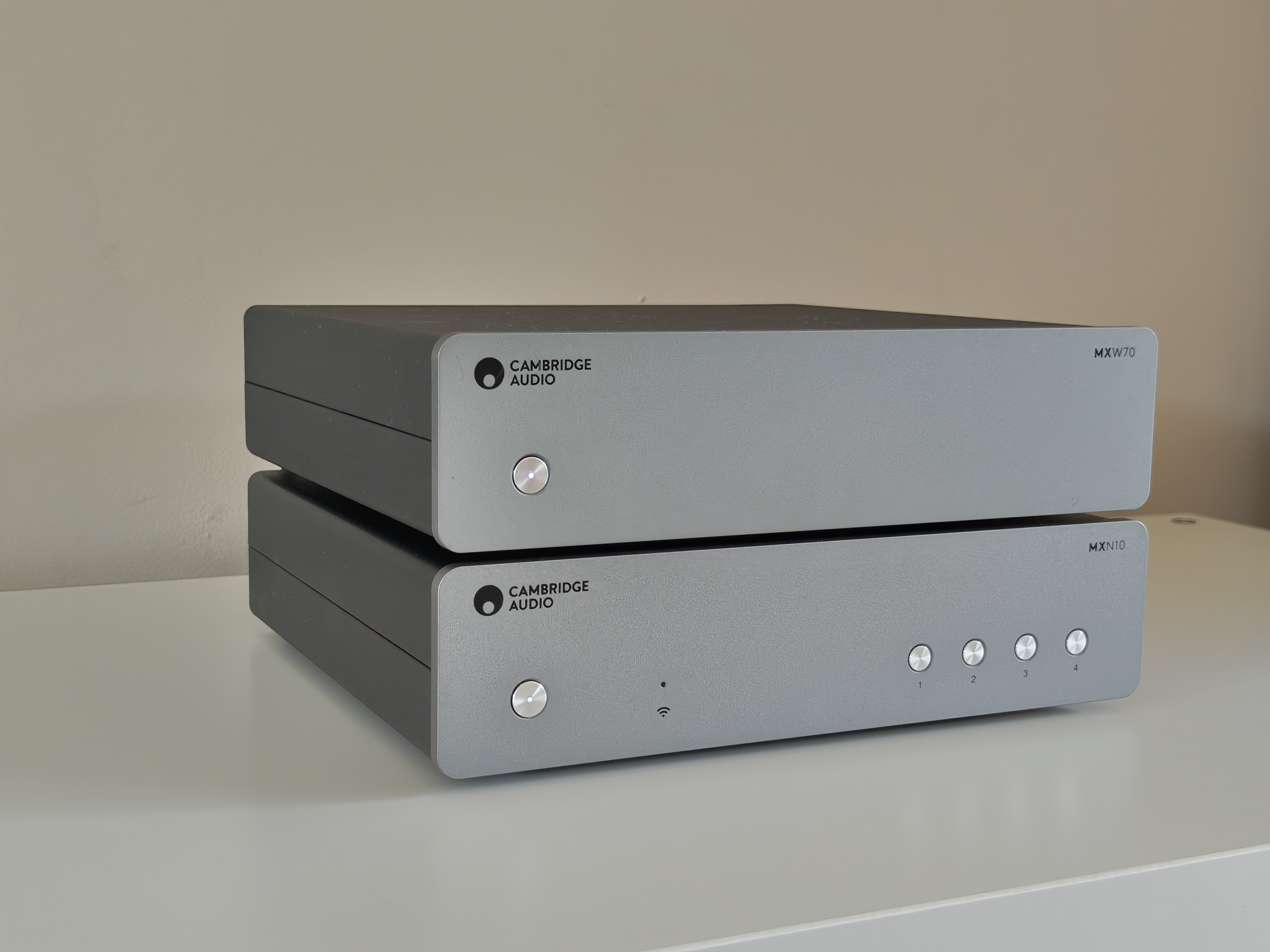 Cambridge Audio MXW70 power amp on book shelf with streamer
