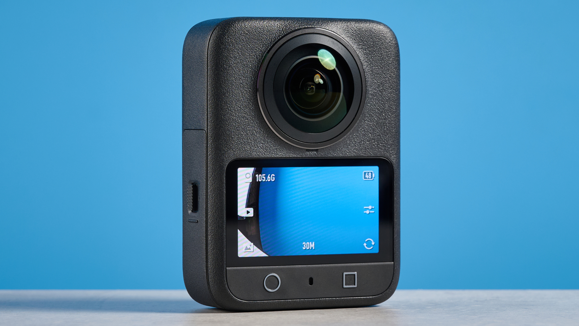 The DJI Osmo 360 screen and rear buttons against a blue background
