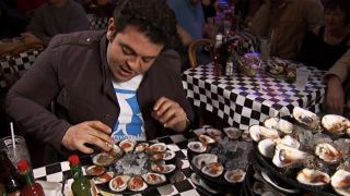 Adam Richman takes on the Acme Oyster House challenge