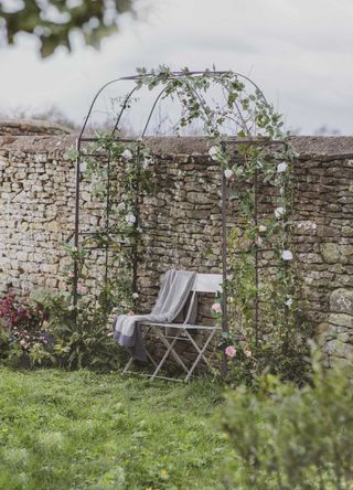 garden arbor ideas: steel arch over bench with climbing roses from Garden Trading