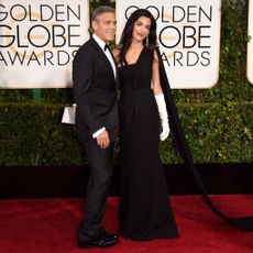 Clothing, Coat, Trousers, Flooring, Suit, Outerwear, Formal wear, Carpet, Style, Dress,