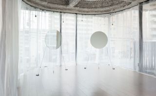 White drapes and mirrors at Flux hair salon, designed by Sides Core, in Kyoto, Japan