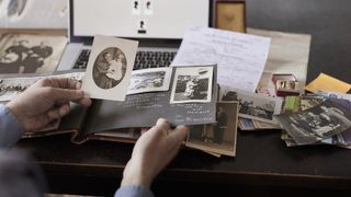 Best family tree makers: Image of person collecting old family photos
