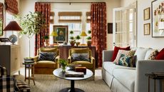 cozy living room decorated with fall colors with ochre velvet armchairs and burgundy burnt orange fabric accents