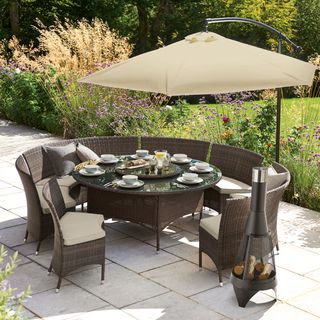 outdoor round dining table and chairs near garden