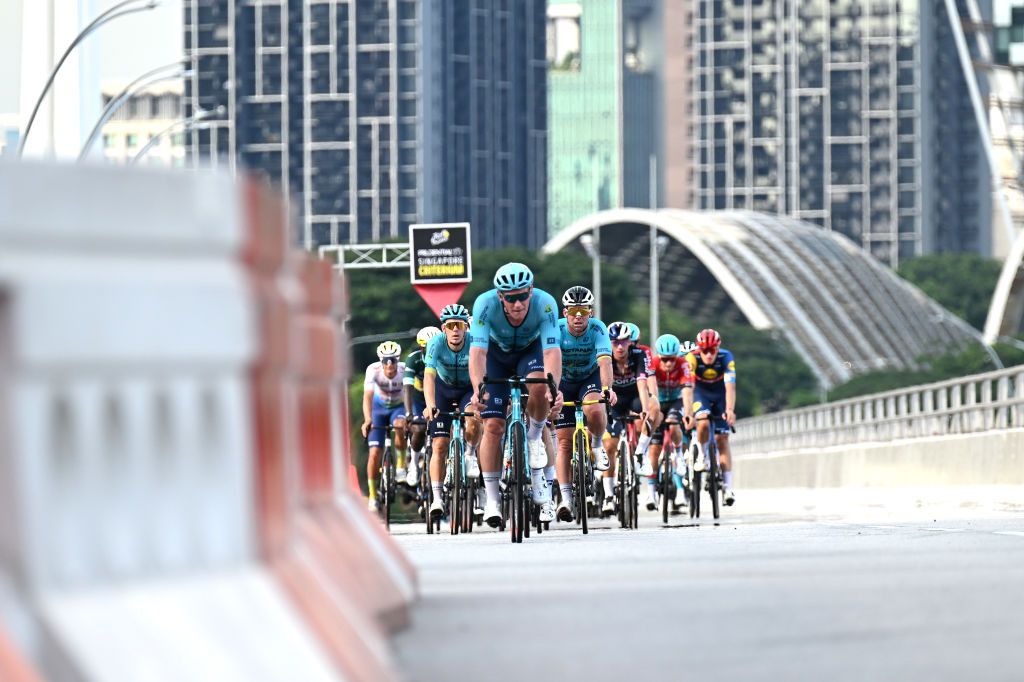 SINGAPORE SINGAPORE NOVEMBER 10 LR Gleb Syritsa of Russia and Mark Cavendish of The United Kingdom and Astana Qazaqstan Team lead the peloton passing the last kilometre red flag during the 3rd Tour de France Prudential Singapore 2024 Criterium a 575km one day race from Singapore to Singapore on November 10 2024 in Singapore Photo by Tim de WaeleGetty Images