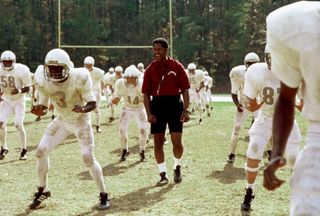 denzel washington coaches a team of football players in Remember the Titans