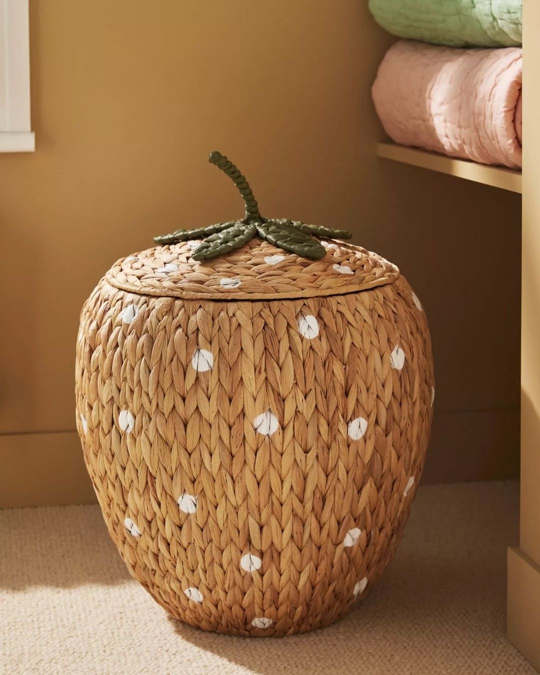 A series of sculptural rattan decorative items, including place mats, cake stands, laundry baskets, lights, napkin rings, and storage units.