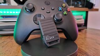 WD Black C50 Xbox storage card leaning on a Series X controller