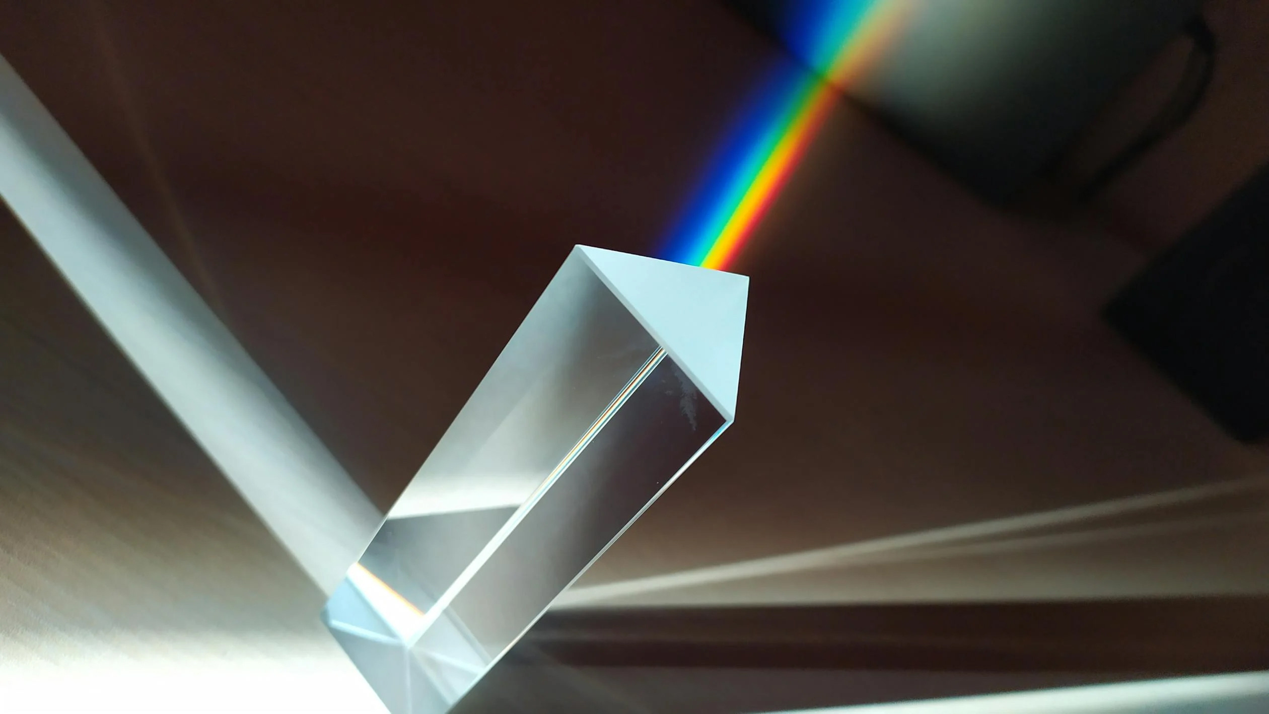 A glass prism casting a rainbow