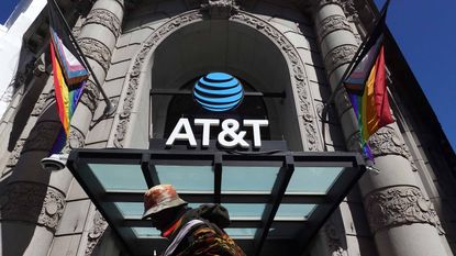 person walks by AT&T flagship store in San Francisco