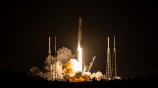 a black and white spacex rocket launches at night