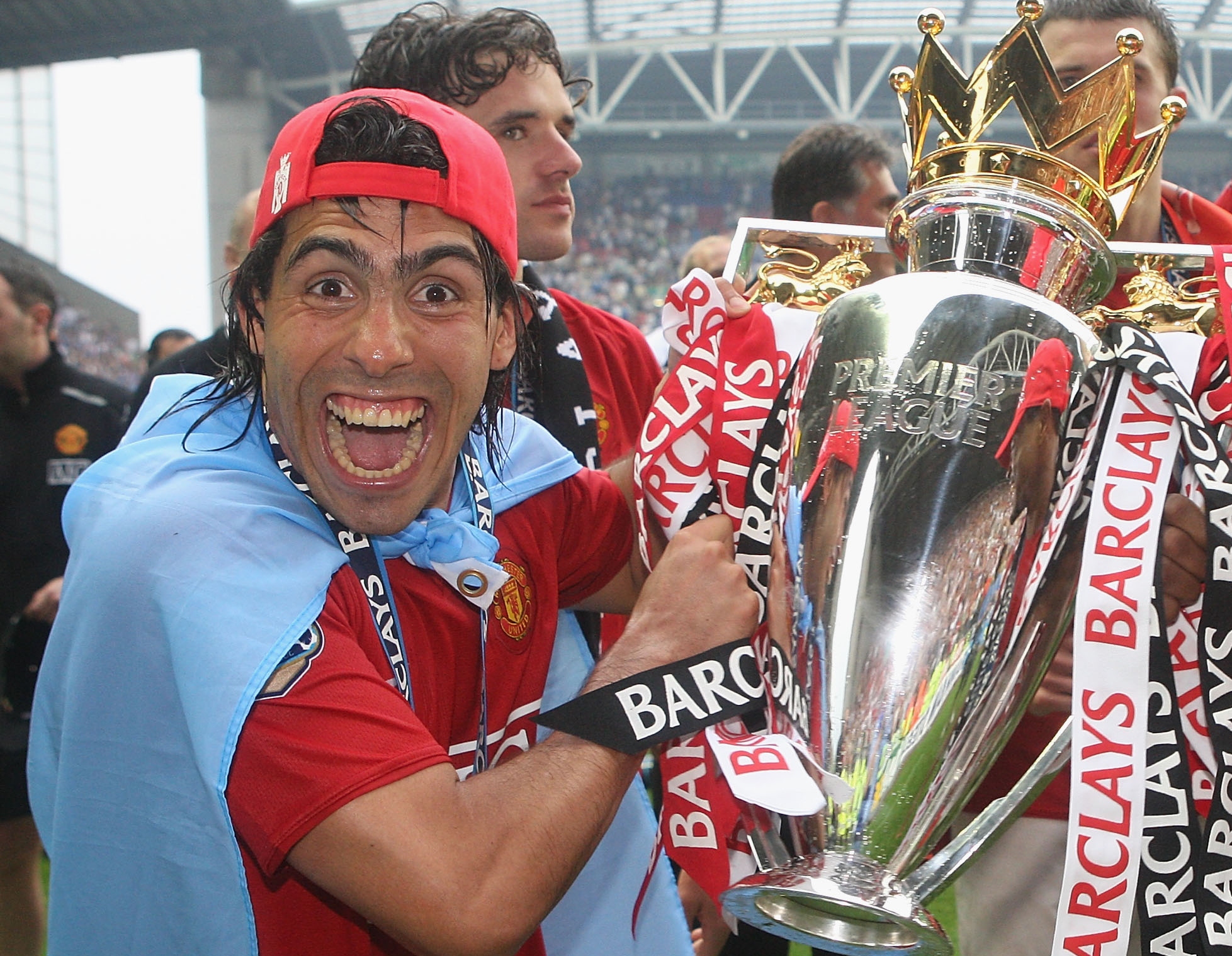 Carlos Tevez celebrates with the Premier League trophy after winning the 2007/08 title with Manchester United