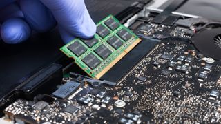 Service engineer install new RAM memory chips to the laptop