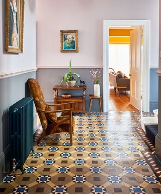 Victorian hallway tiles in yellow, brown and blue, with powder blue and pink walls