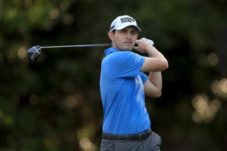 Cantlay watches his tee shot after hitting a driver