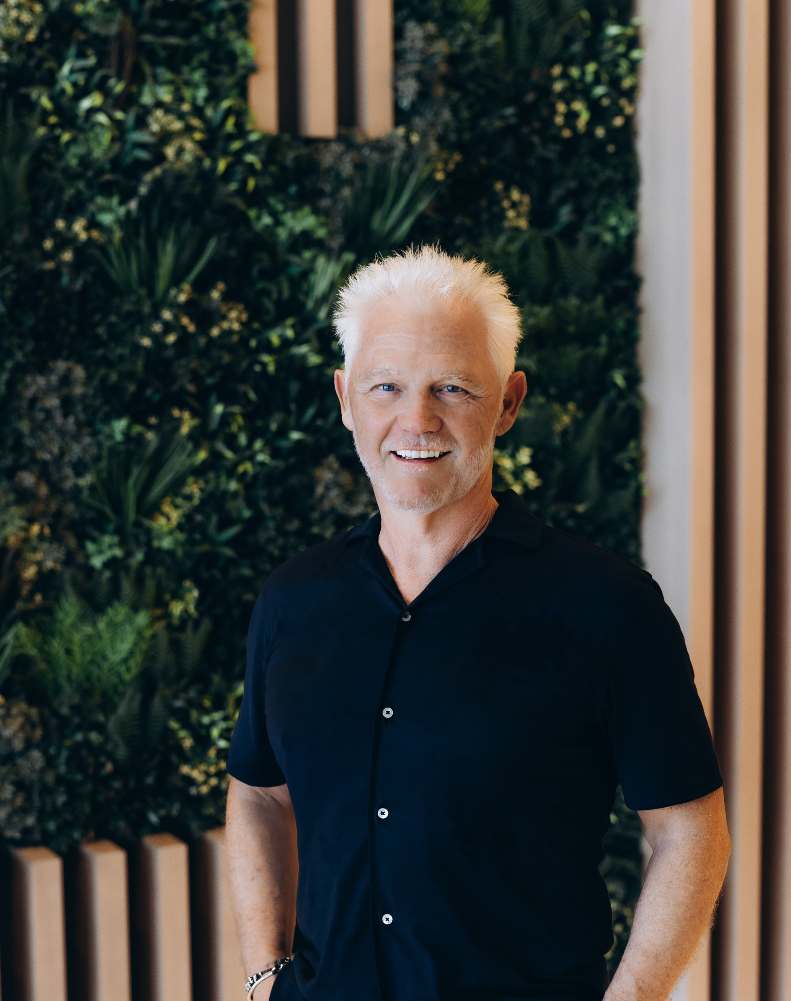 a white man with white hair in a black shirt