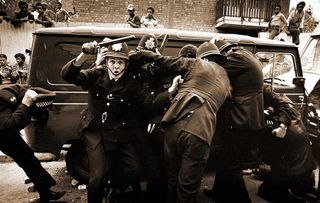 Police take shelter at the 1976 Notting Hill riots