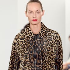 Amber Valletta modeling a leopard-print coat at the FW24 Michael Kors show.