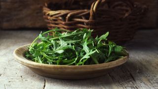 wooden bowl of arugula