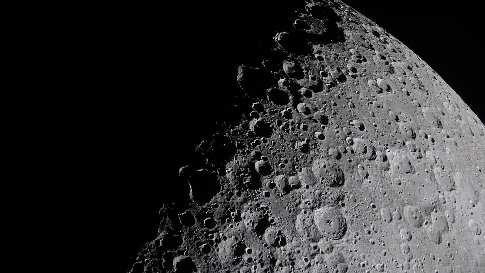 closeup of the moon's cratered gray surface