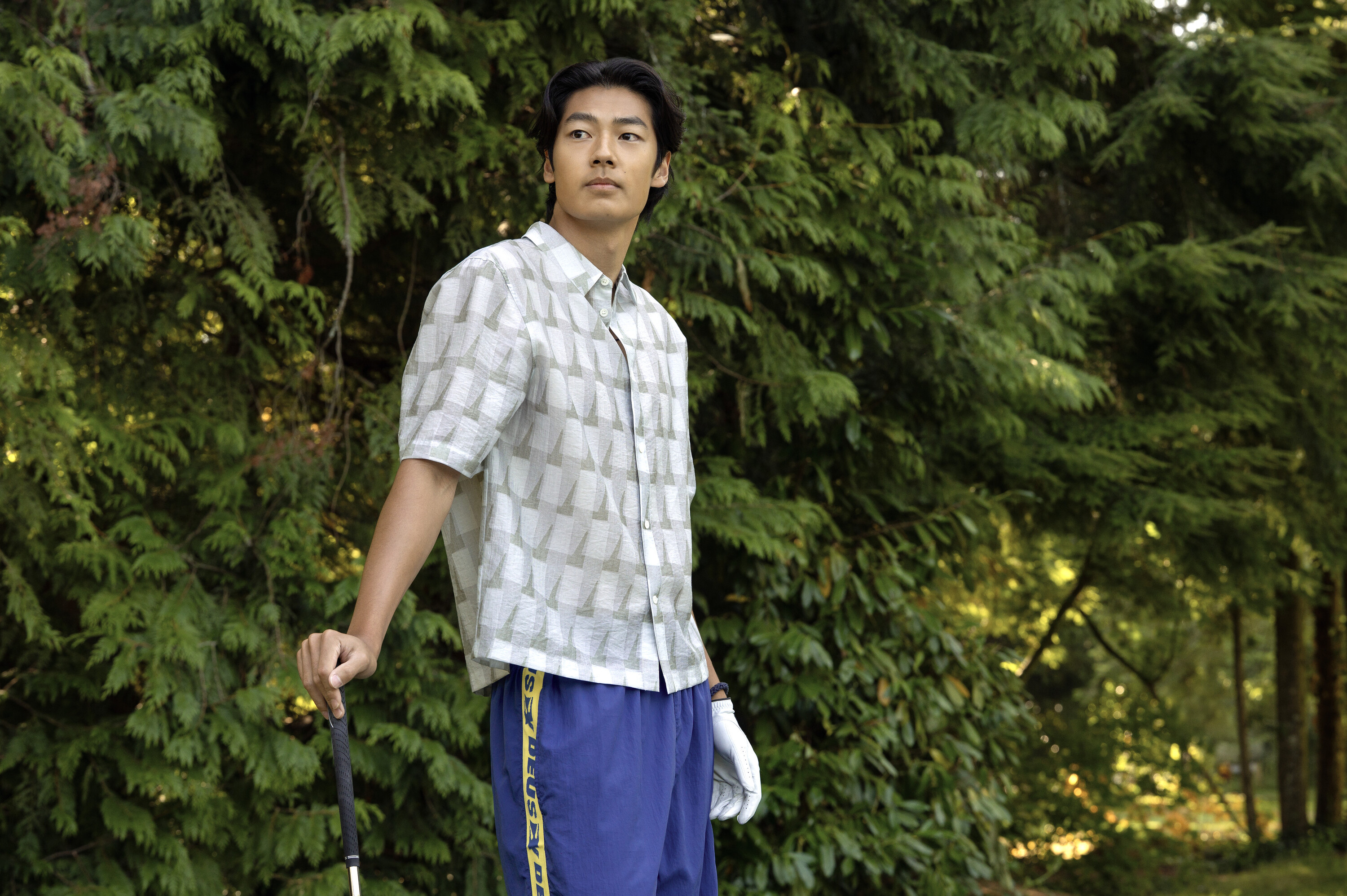 Joseph Chiu as Jordie wearing a printed shirt and basketball shorts on a hike in a scene from 'Every Year After.'