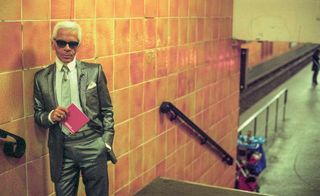 Coloured portrait of Karl Lagerfeld leaning against a wall