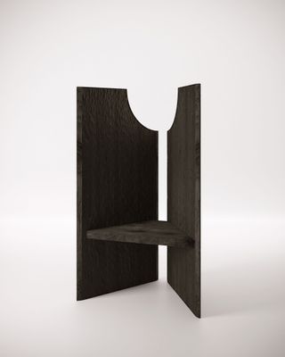 View of the black wooden ‘Nut’ throne by Studiopepe pictured against a light coloured background