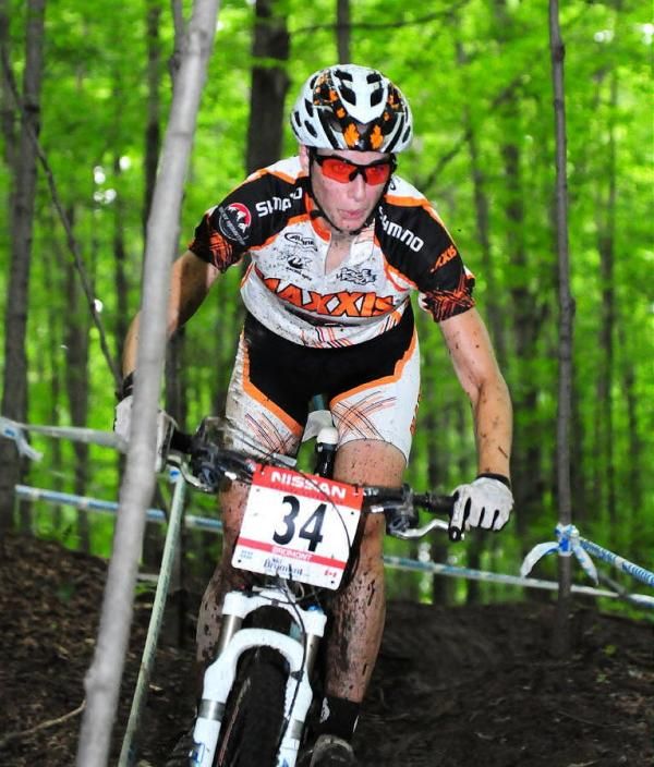 Lea Davison (Team Maxxis-Rocky Mountain) riding through the trees.