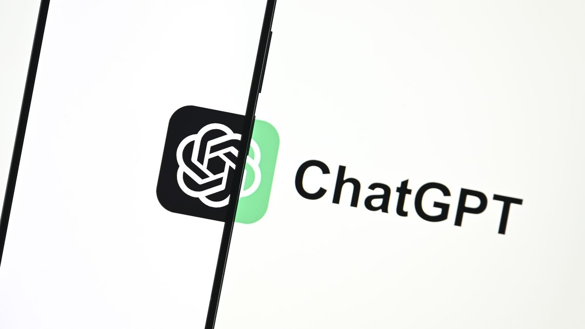 ChatGPT Enterprise: A phone in the left half of the frame, with an all-white screen except for two-thirds of the OpenAI logo (overlapping circles in a knot shape) that is completed by a green version of the logo on the otherwise white background behind the phone. To the right of the logo, black text reads &#039;ChatGPT&#039;.