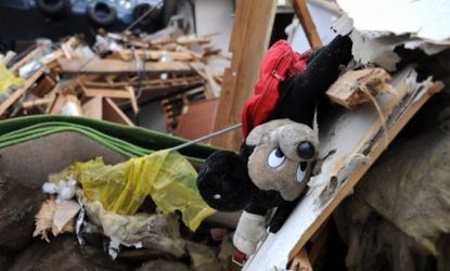 A child's toy surrounded by the wreckage from last week's earthquake: Japan's crisis has since escalated into a nuclear catastrophe, and thousands of people are still missing.