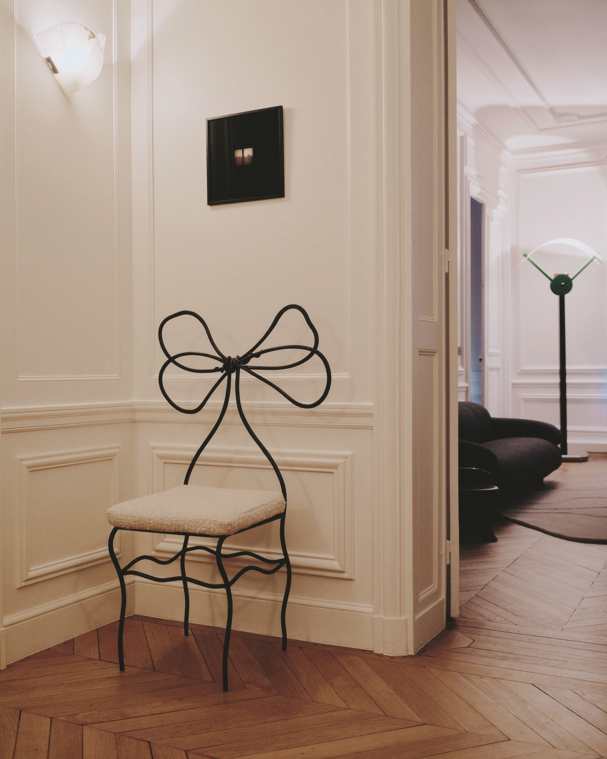 a minimalist room with a iron bow dining chair