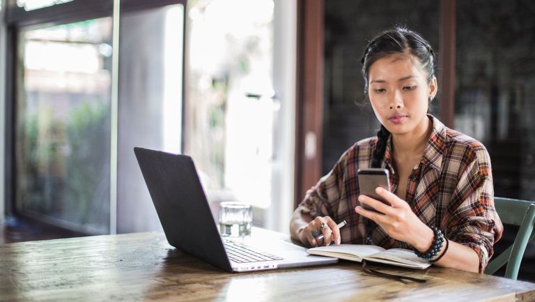 a young beautiful woman works at her laptop in a modern office space