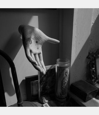 black and white image of mannequin hand on a stand, from Larry Fink photography book