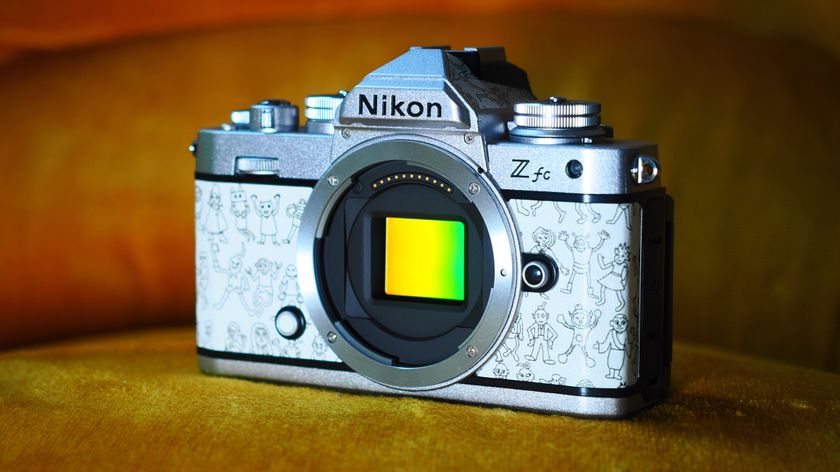 Nikon Z fc Heralbony &#039;Joyful Time&#039; edition camera with its sensor exposed, sitting on a burnt-sand background