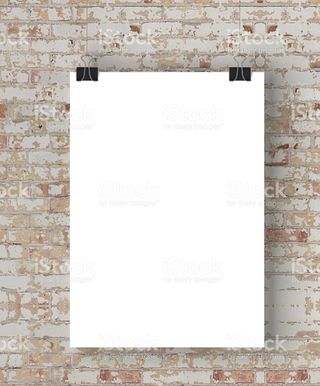 Blank poster hanging on brick wall