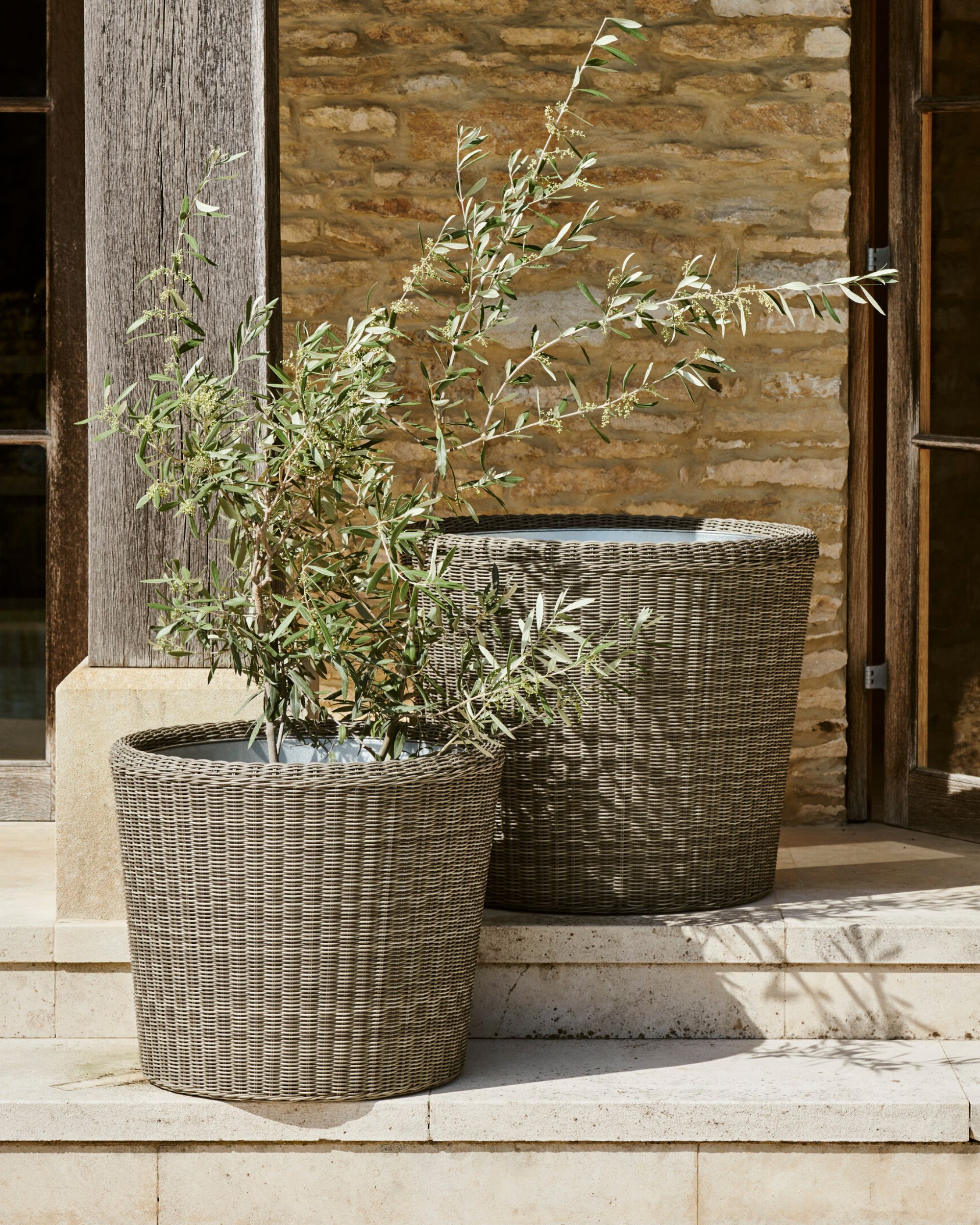 set of two wicker garden planters on a patio.