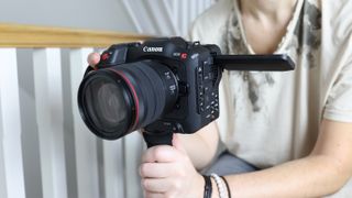 Canon EOS C70 being held by one of our reviewers