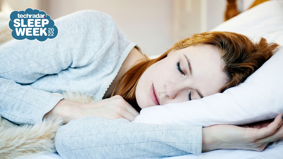 Woman asleep in bed on her side