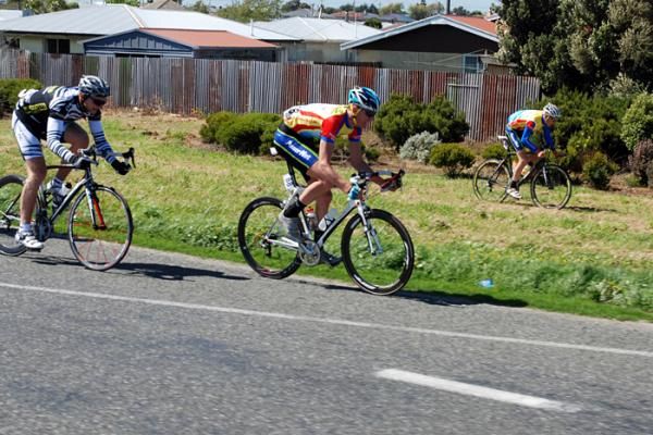 A rider is blown off the road and onto the grass verge