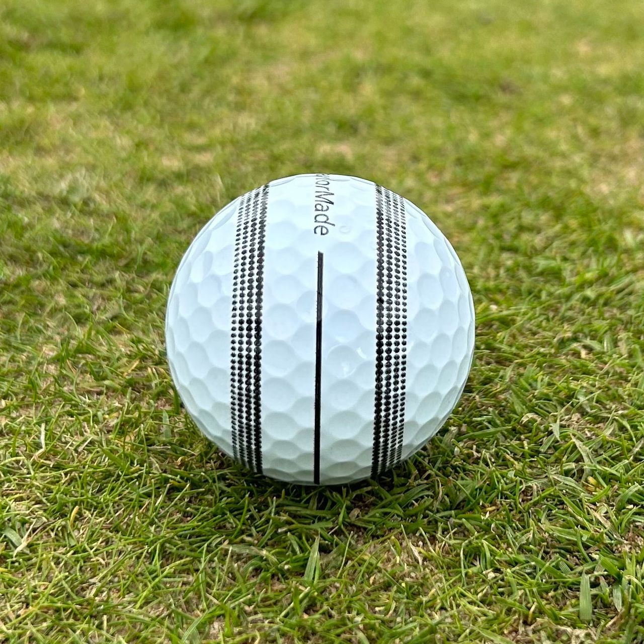 TP5 stripe golf ball lined up to the hole